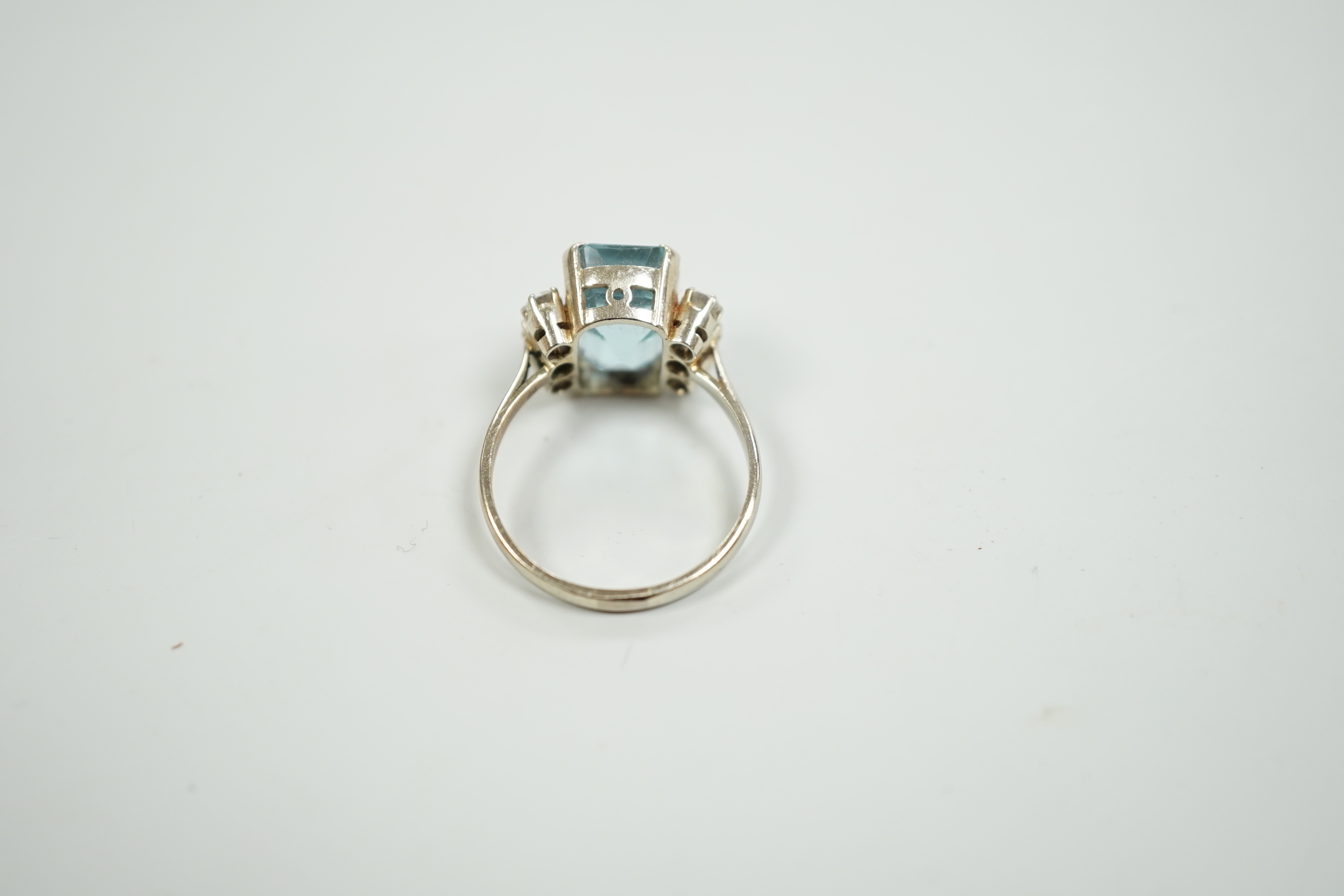 A white metal and single stone emerald cut aquamarine and six stone diamond set dress ring, size P/Q, gross weight 4.2 grams.
